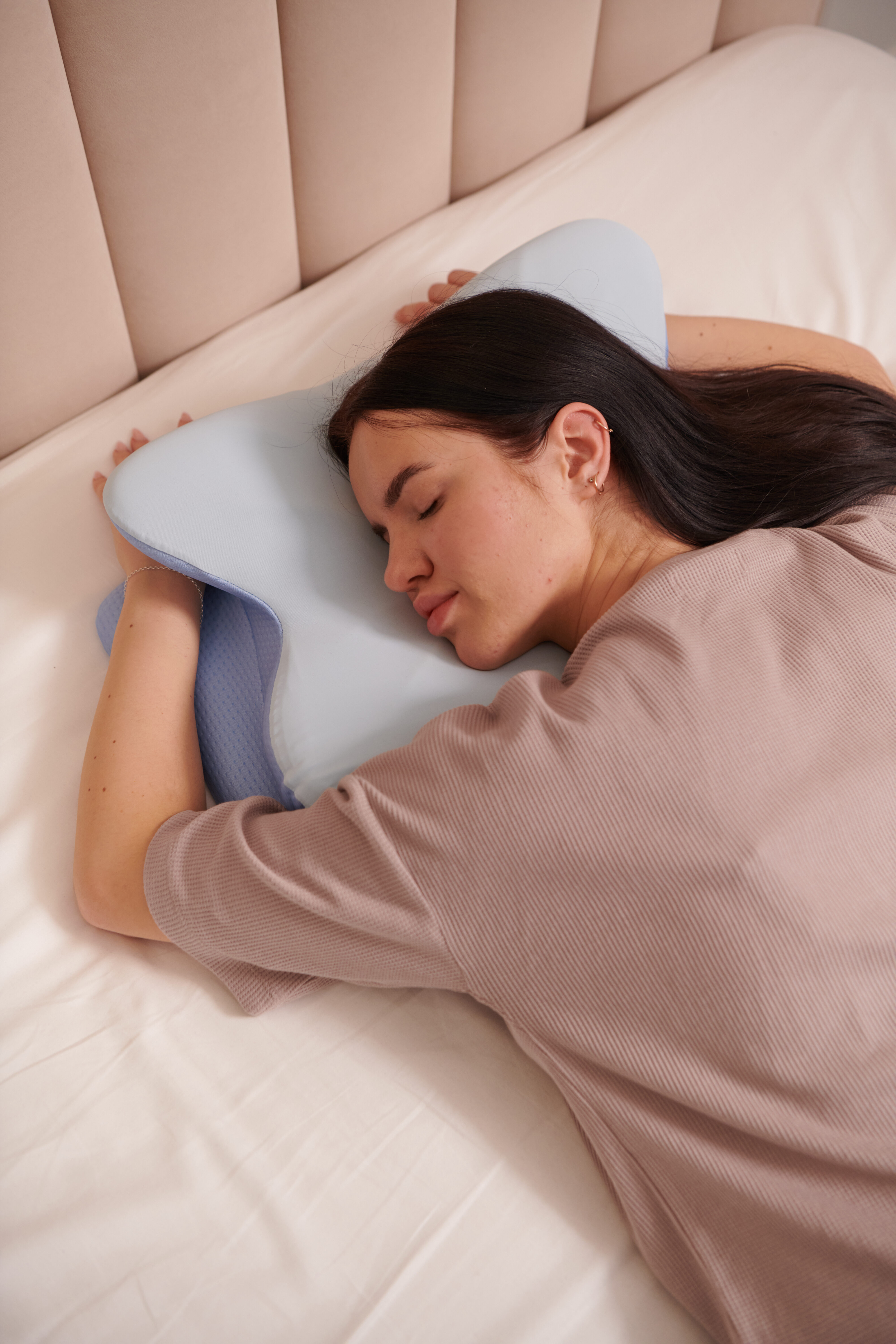 Woman waking up happy and refreshed after a full night's sleep